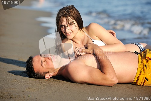 Image of happy young couple have fun on beach