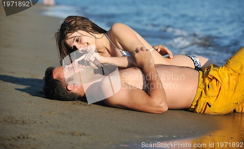 Image of happy young couple have romantic time on beach