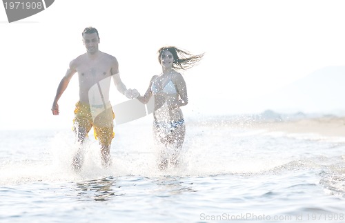 Image of happy young couple have romantic time on beach