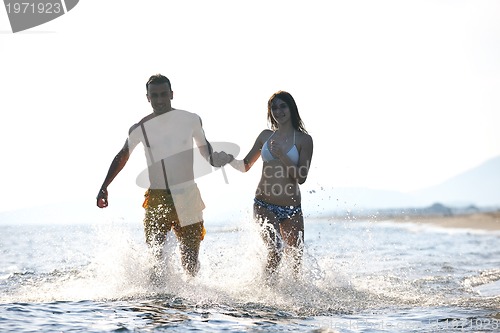 Image of happy young couple have fun on beach