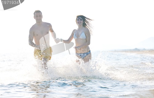 Image of happy young couple have romantic time on beach