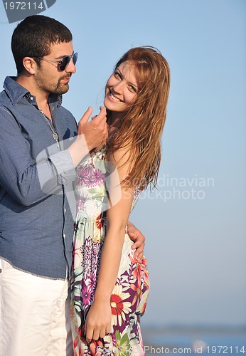 Image of happy young couple have romantic time on beach