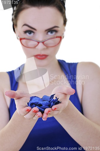 Image of young woman holding blue flower in hands