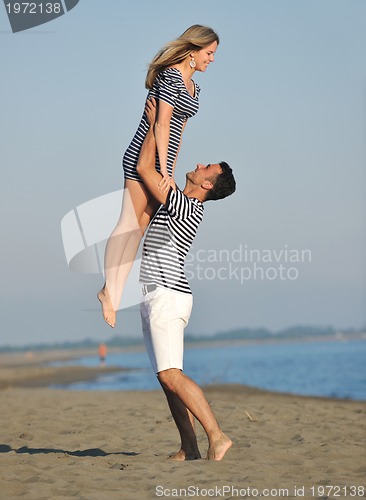 Image of happy young couple have romantic time on beach