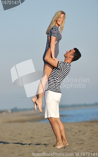 Image of happy young couple have romantic time on beach