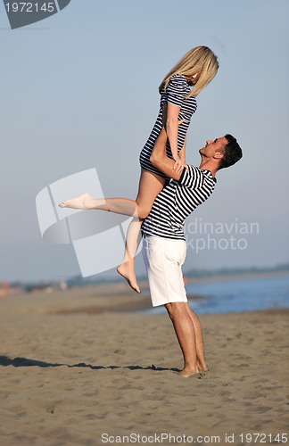 Image of happy young couple have fun on beach