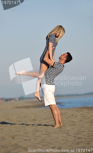 Image of happy young couple have fun on beach