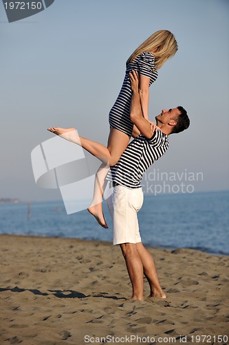 Image of happy young couple have fun on beach