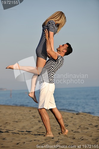 Image of happy young couple have fun on beach