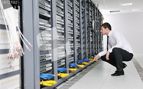 Image of young it engeneer in datacenter server room