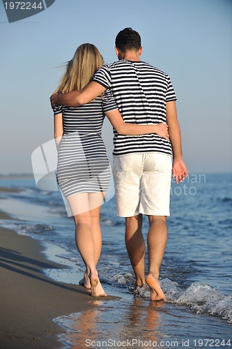 Image of happy young couple have romantic time on beach