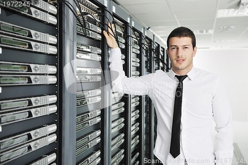 Image of young it engeneer in datacenter server room