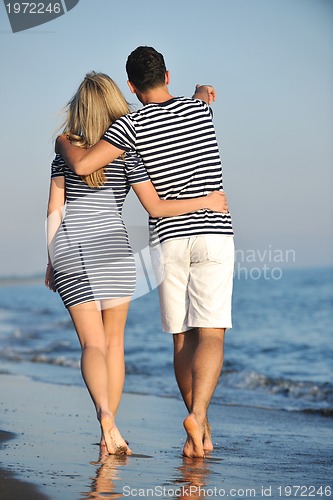 Image of happy young couple have romantic time on beach