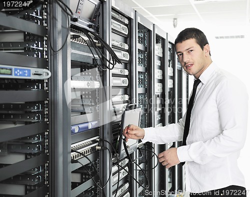 Image of young it engeneer in datacenter server room