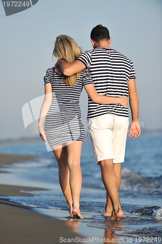Image of happy young couple have romantic time on beach