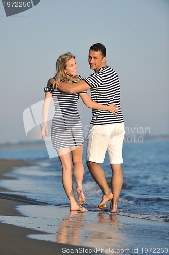 Image of happy young couple have romantic time on beach