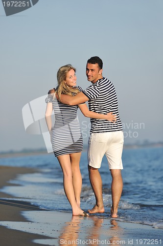 Image of happy young couple have romantic time on beach