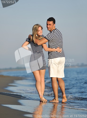 Image of happy young couple have romantic time on beach