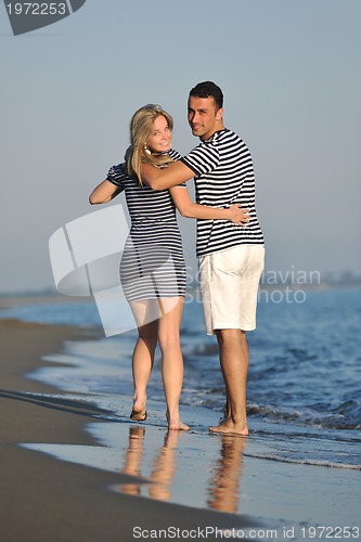 Image of happy young couple have romantic time on beach