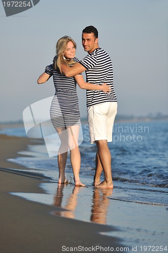 Image of happy young couple have romantic time on beach