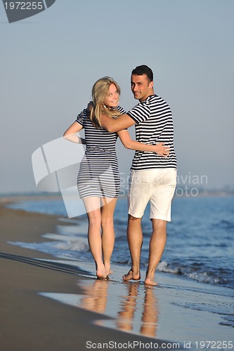Image of happy young couple have romantic time on beach