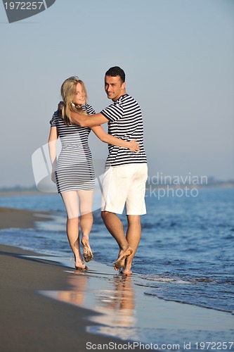 Image of happy young couple have romantic time on beach