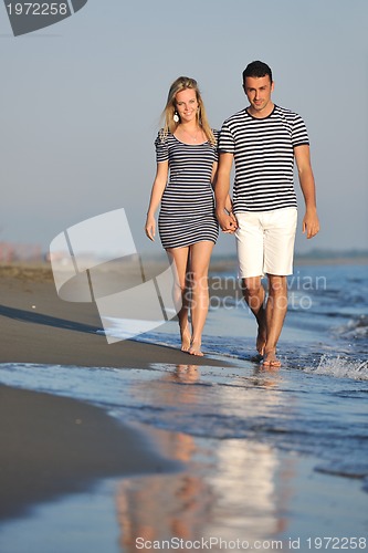 Image of happy young couple have romantic time on beach