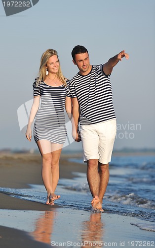 Image of happy young couple have romantic time on beach