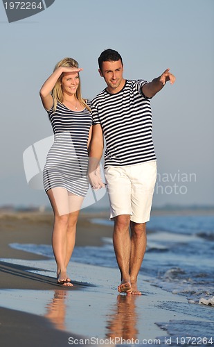 Image of happy young couple have romantic time on beach