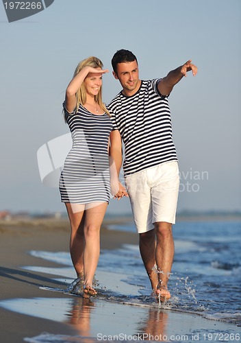 Image of happy young couple have romantic time on beach