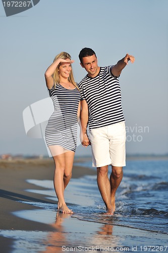 Image of happy young couple have romantic time on beach