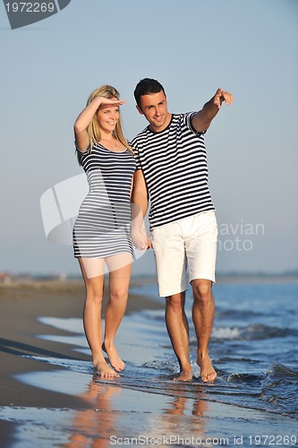 Image of happy young couple have romantic time on beach