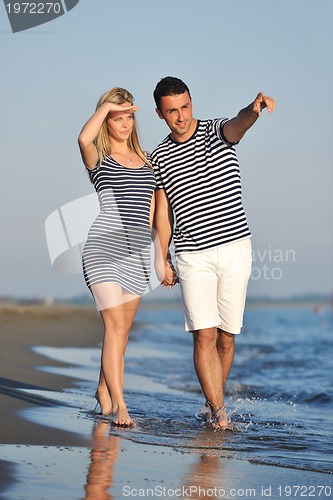 Image of happy young couple have romantic time on beach