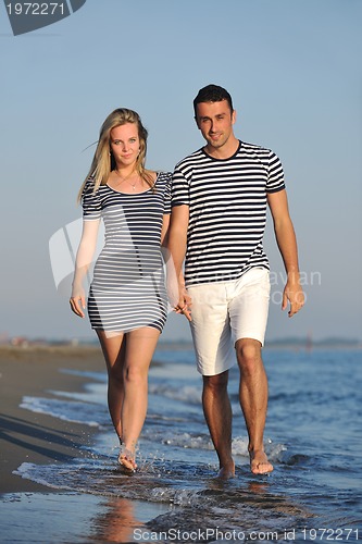 Image of happy young couple have romantic time on beach