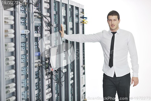 Image of young it engeneer in datacenter server room