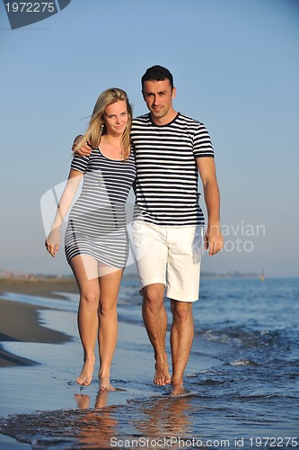 Image of happy young couple have romantic time on beach