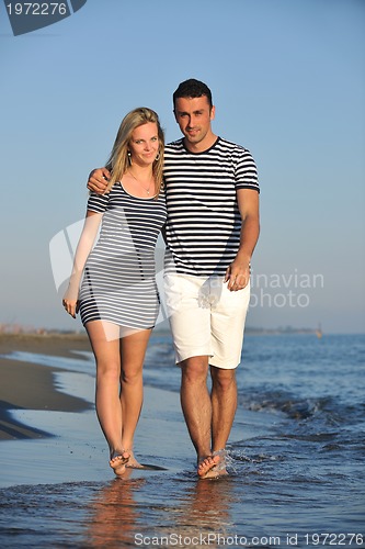 Image of happy young couple have romantic time on beach