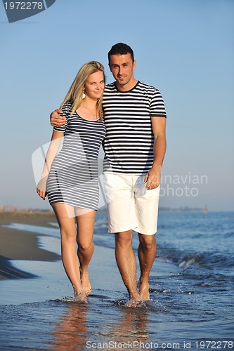 Image of happy young couple have romantic time on beach