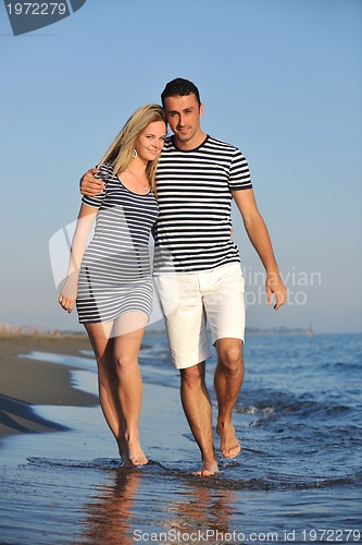 Image of happy young couple have romantic time on beach
