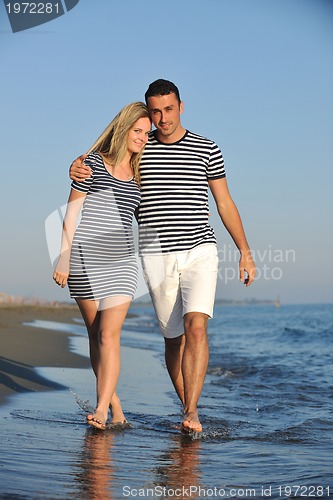 Image of happy young couple have romantic time on beach