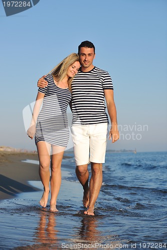 Image of happy young couple have romantic time on beach
