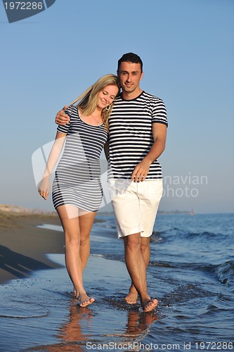 Image of happy young couple have romantic time on beach