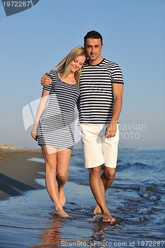 Image of happy young couple have romantic time on beach