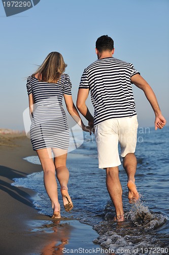 Image of happy young couple have romantic time on beach