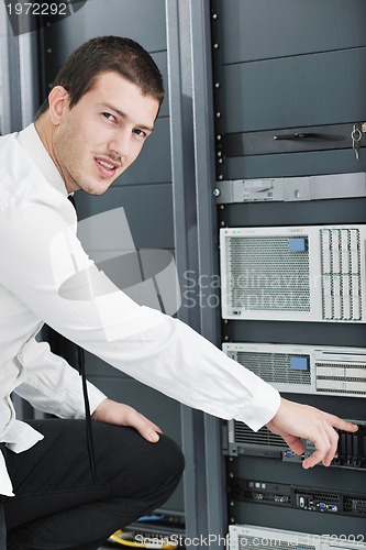 Image of young it engeneer in datacenter server room