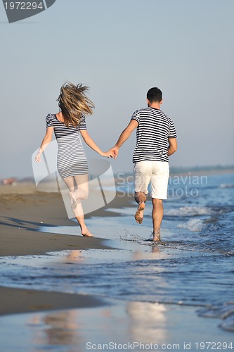 Image of happy young couple have romantic time on beach