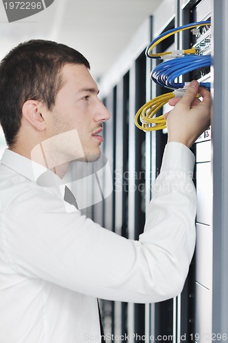 Image of young it engeneer in datacenter server room