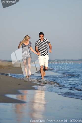 Image of happy young couple have romantic time on beach