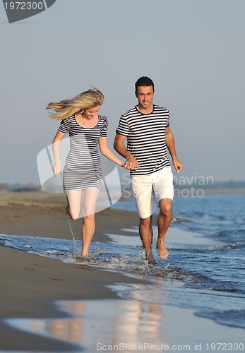 Image of happy young couple have romantic time on beach
