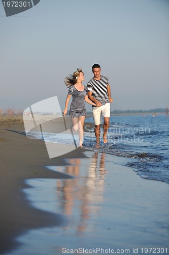 Image of happy young couple have romantic time on beach